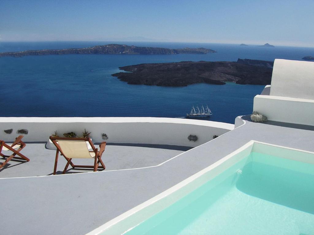a view of the ocean from the balcony of a house at Irida - Santorini in Imerovigli
