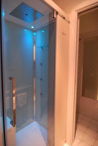 a glass shower in a bathroom with a blue ceiling at Albergo La Conca Azzurra in Conca dei Marini