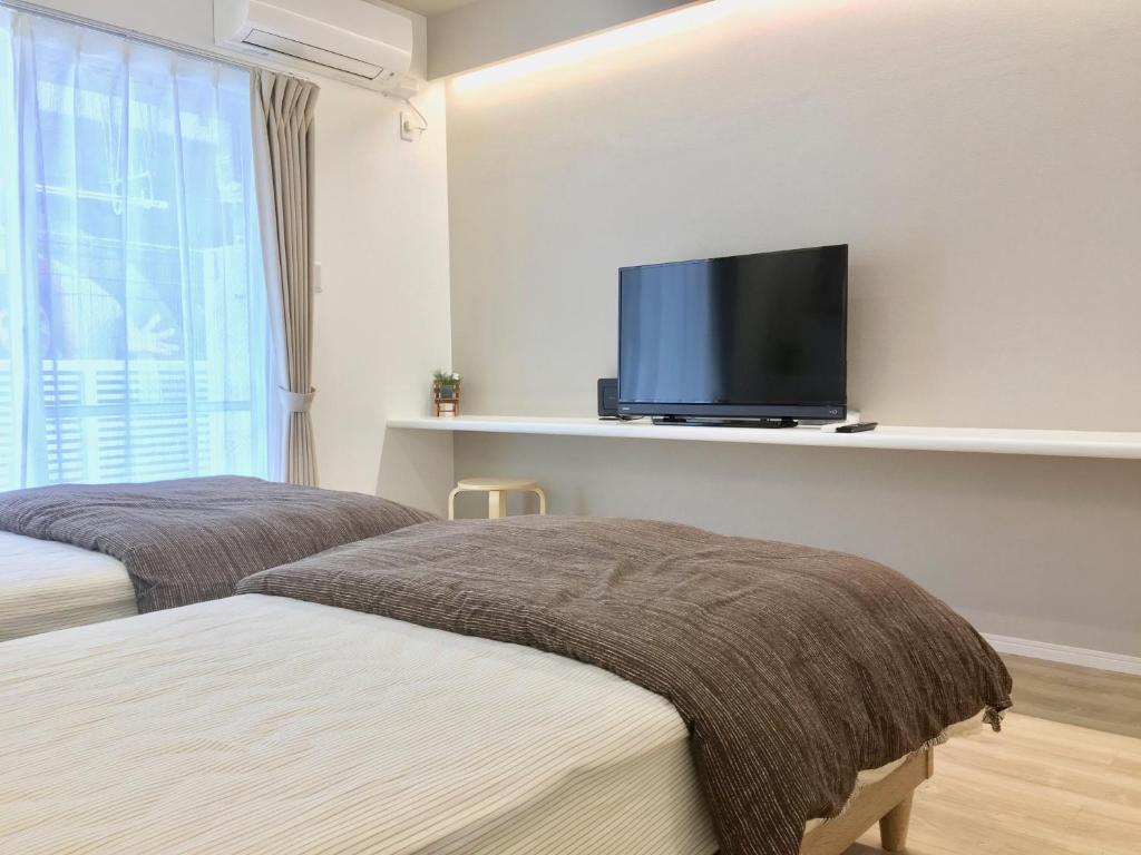 Llit o llits en una habitació de A-Style Futenma