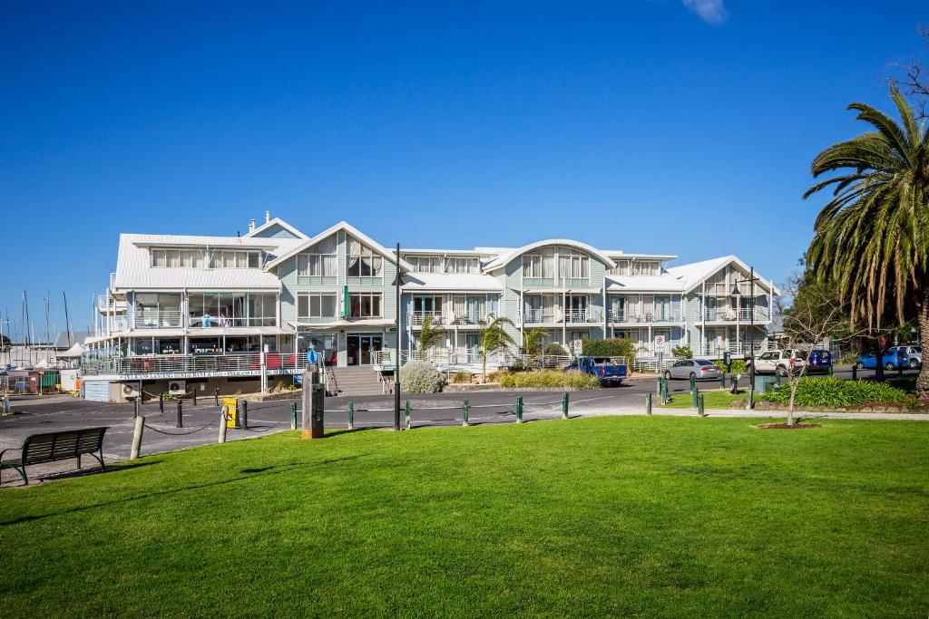 a large building with a park in front of it at Aligned Corporate Residences Williamstown in Williamstown