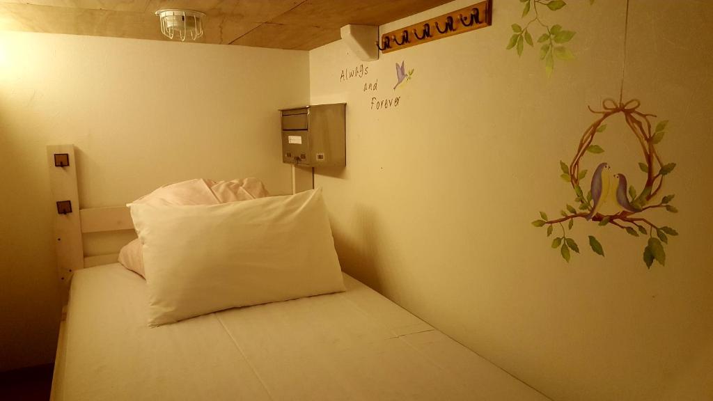 Postel nebo postele na pokoji v ubytování Shinjuku Sky hostel