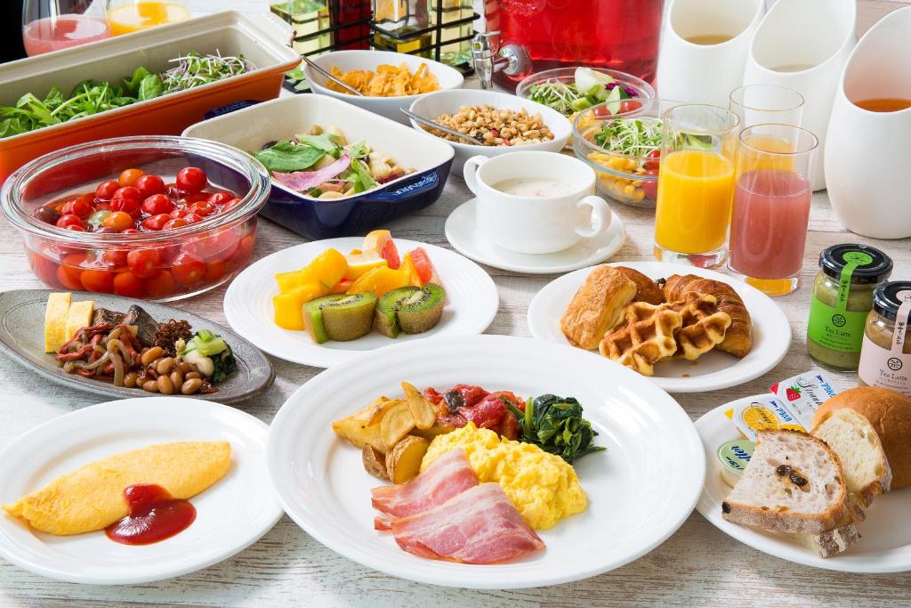 a table with plates of breakfast foods and drinks at Lake Biwa Otsu Prince Hotel in Otsu