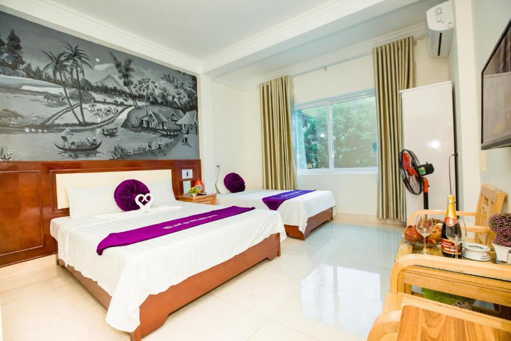 Postel nebo postele na pokoji v ubytování Dang Quang Guesthouse