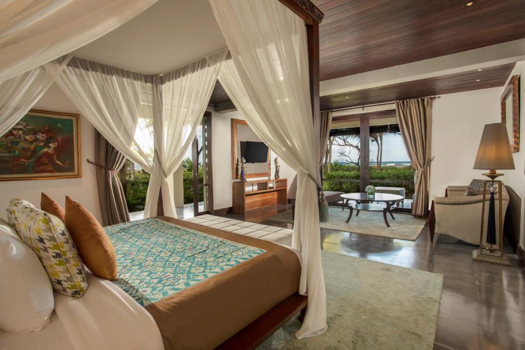 a bedroom with a bed and a living room at Jeeva Saba Bali in Saba