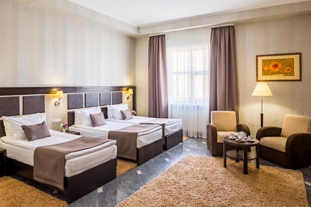 Ліжко або ліжка в номері Taurus Hotel & SPA