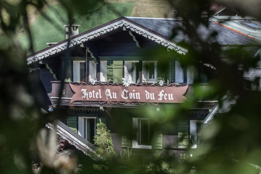 a building with a sign on the side of it at Au Coin Du Feu in Megève