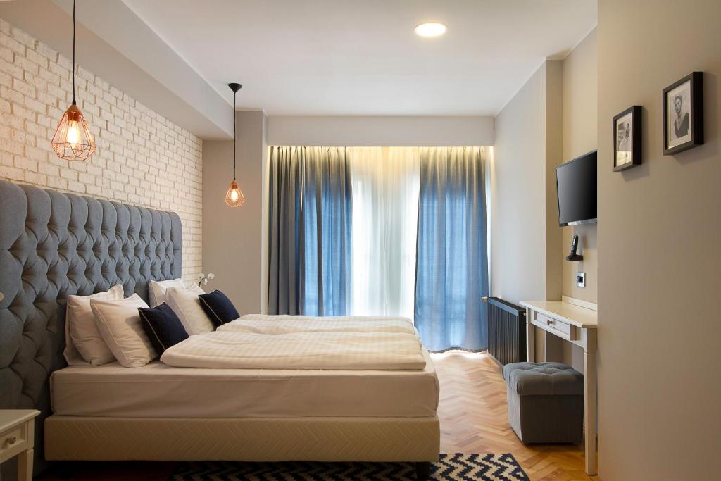 Un dormitorio con una cama grande y una ventana en Venis Boutique Hotel, en Bucarest
