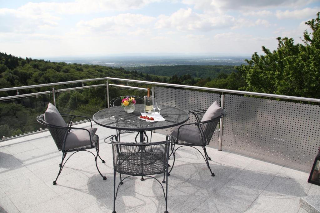 a table and chairs on a balcony with a view at Apartment Sonnenterrasse in Baden-Baden
