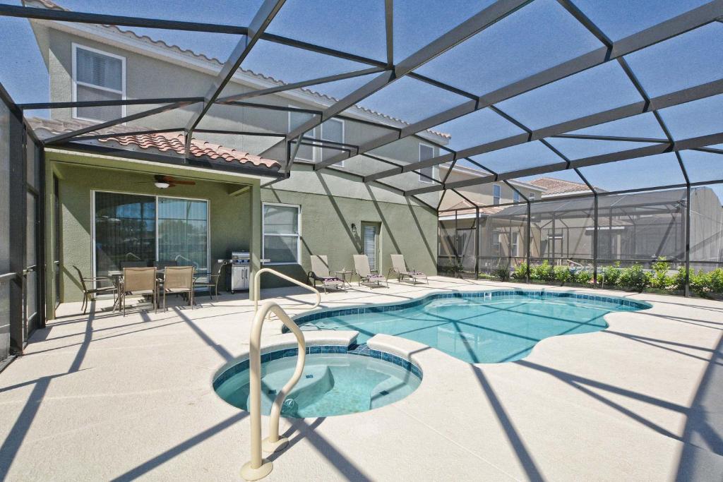 a patio with a swimming pool with a glass roof at Solterra - 6 Bedrooms House w/pool-7040SR in Davenport