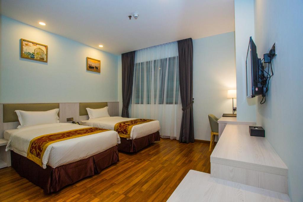 Postel nebo postele na pokoji v ubytování Austin Park Hotel