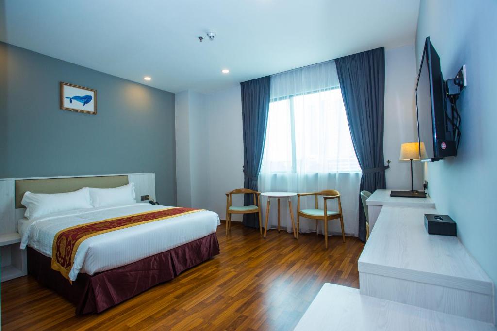 Postel nebo postele na pokoji v ubytování Austin Park Hotel
