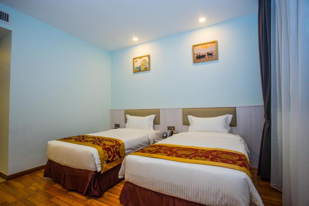 Postel nebo postele na pokoji v ubytování Austin Park Hotel