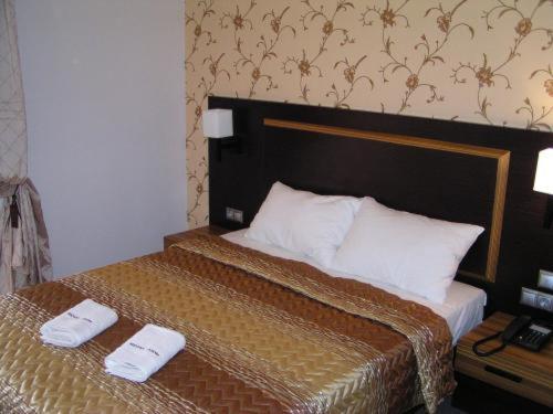 Postel nebo postele na pokoji v ubytování Dion Hotel
