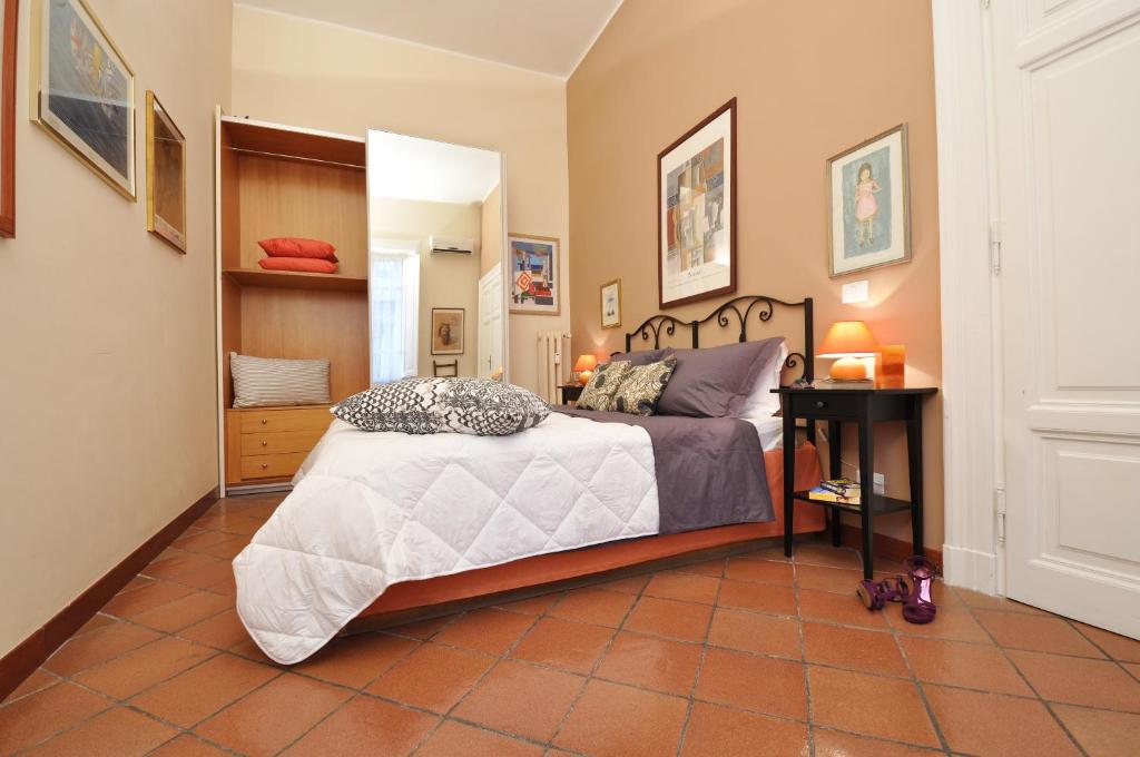 a bedroom with a bed and a tiled floor at Casa Visconti in Rome