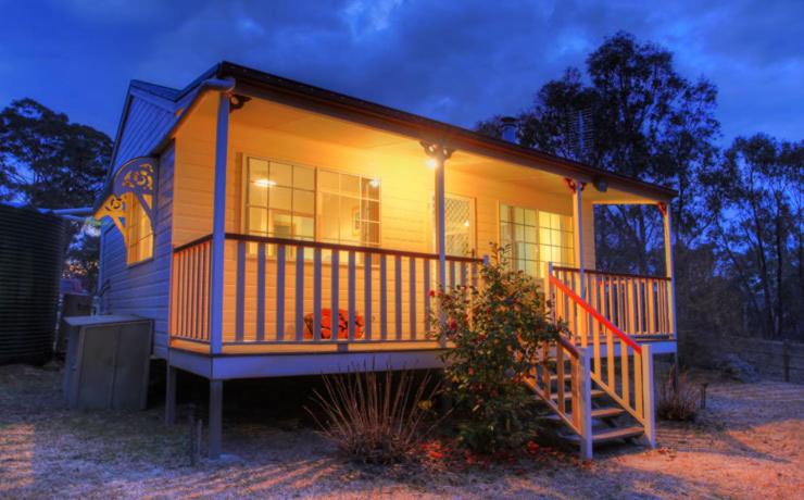 a small house with a light on the front of it at Accommodation Creek Cottages & Sundown View Suites in Ballandean