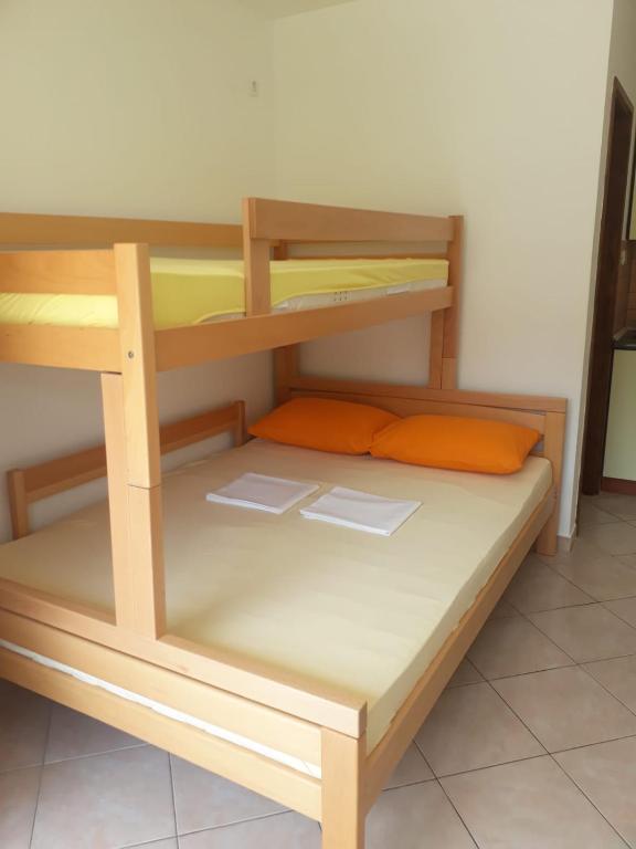 a wooden bunk bed in a small room at Apartmani Ruža in Novalja