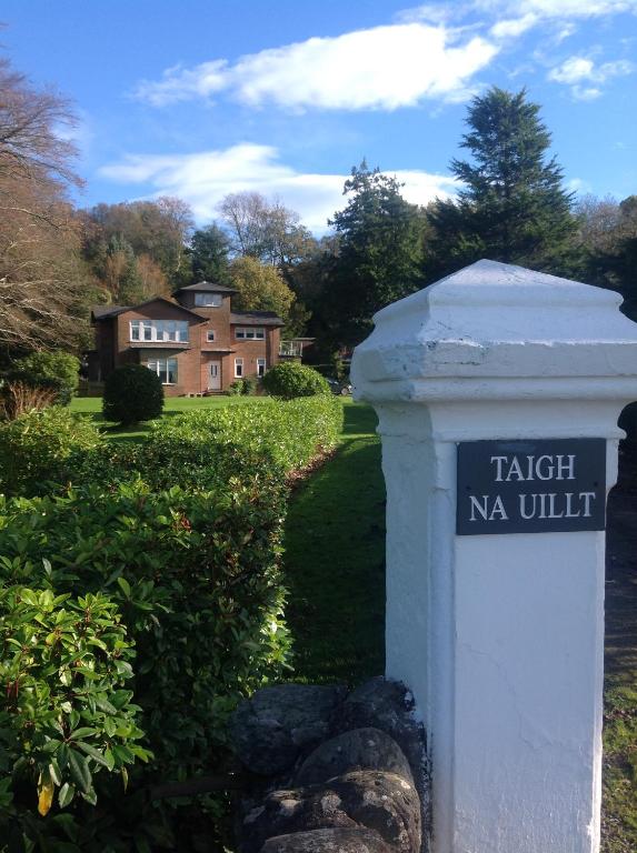 a sign for a yard with a house in the background at Taigh Na Uillt in Cove