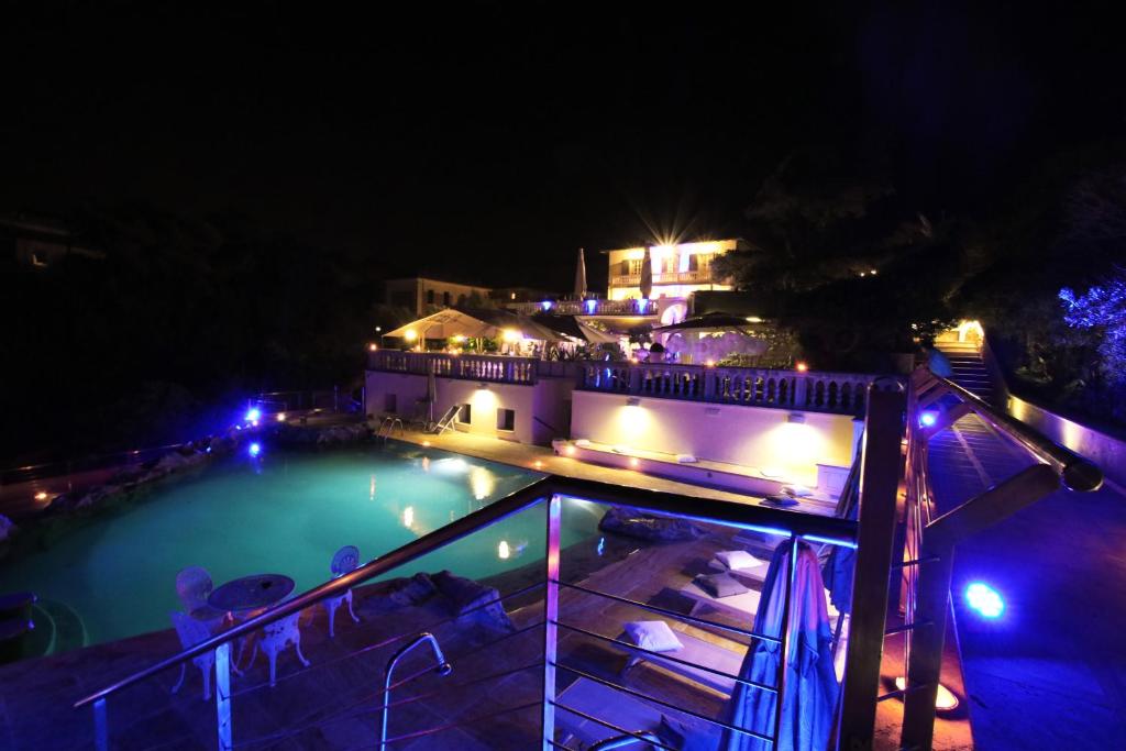 a house with a swimming pool at night at Hotel Villa Margherita in Quercianella
