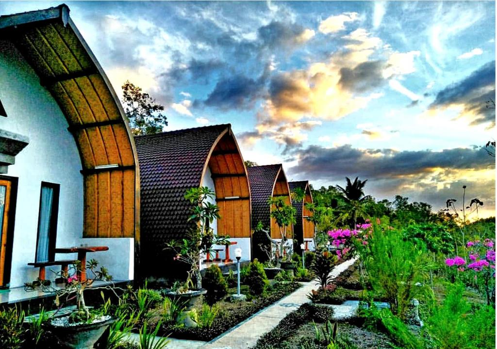 a building with a bunch of plants in front of it at Sebrang Hills Bungalow in Nusa Penida
