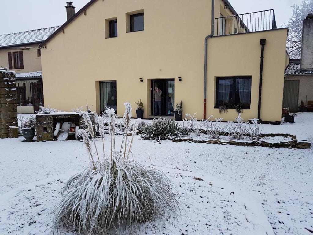 a house with snow on the ground in front of it at LES JARDINS DE LA GRANGE in Rezonville