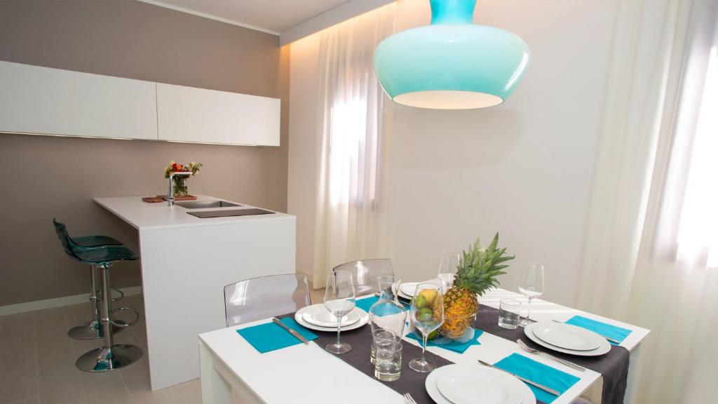 a dining room with a table and a blue light at Hotel President in Lignano Sabbiadoro