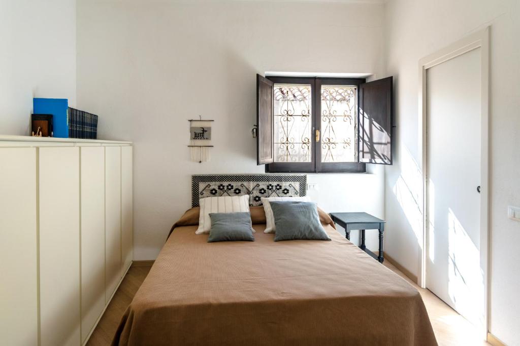 a bedroom with a large bed with two pillows at San Domenico 66 in Cagliari