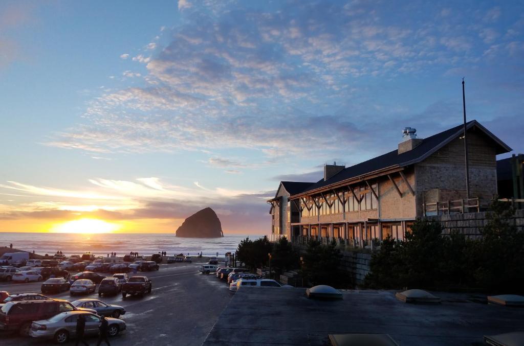 a parking lot with a building next to the ocean at Headlands Coastal Lodge & Spa in Pacific City