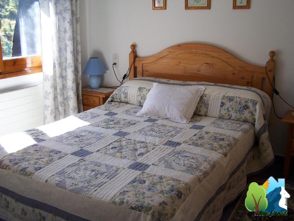 ein Schlafzimmer mit einem Bett mit einer Decke darauf in der Unterkunft Soldeu Paradis Incles in Incles