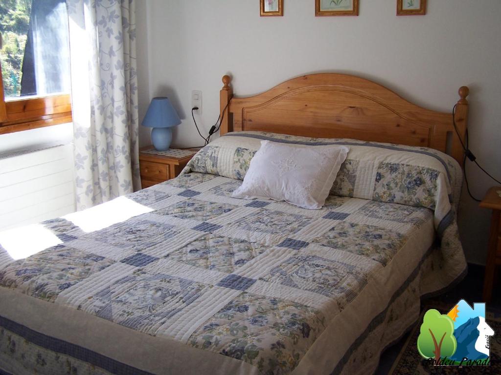 a bedroom with a bed with a quilt on it at Soldeu Paradis Incles in Incles