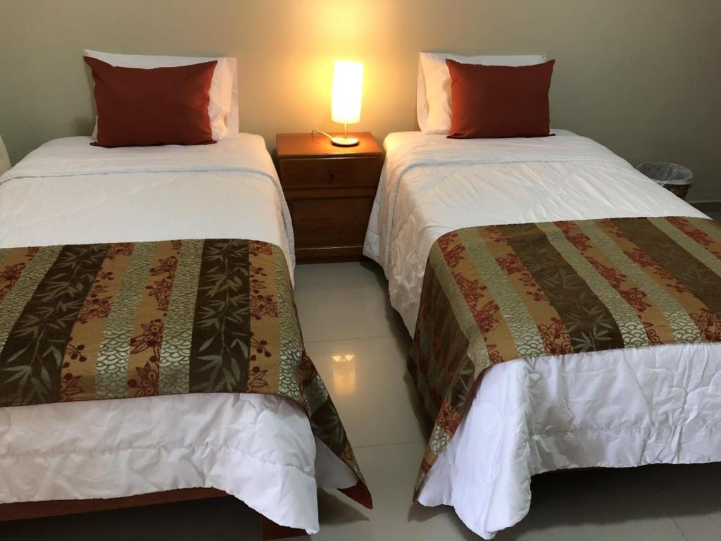 Postel nebo postele na pokoji v ubytování La Floresta Tarapoto Hostal