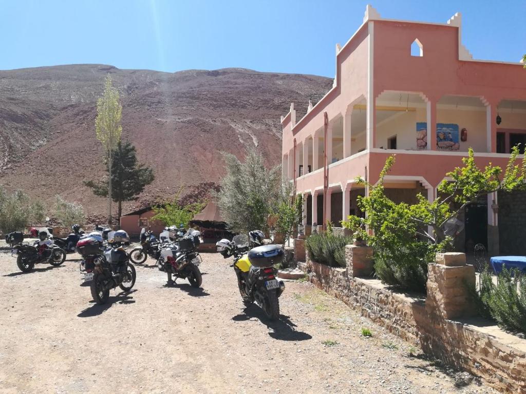 a group of motorcycles parked in front of a building at Auberge Bougafer in Tamtetoucht