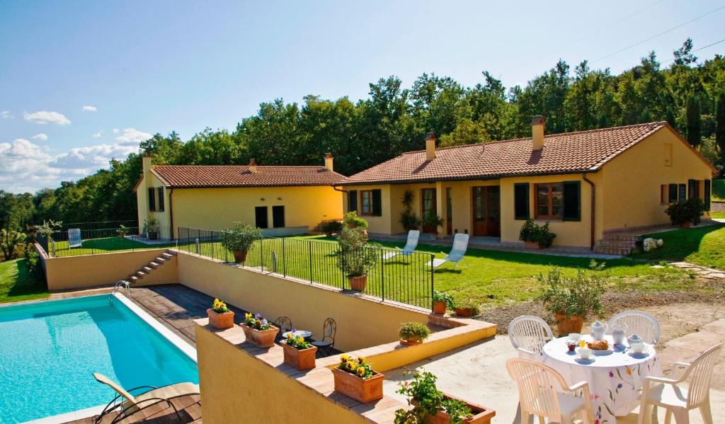 a villa with a swimming pool and a house at Podere Casalsole in Certaldo