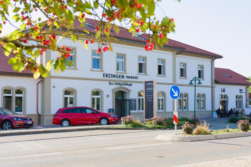 a building with a red car parked in front of it at Bahnhof-Erzingen, hotel, coffee & more in Erzingen