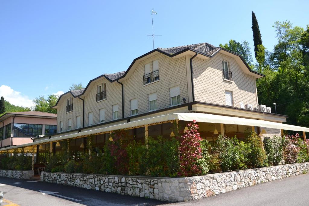 un grand bâtiment avec des fleurs devant lui dans l'établissement Hotel Edoné, à Roe