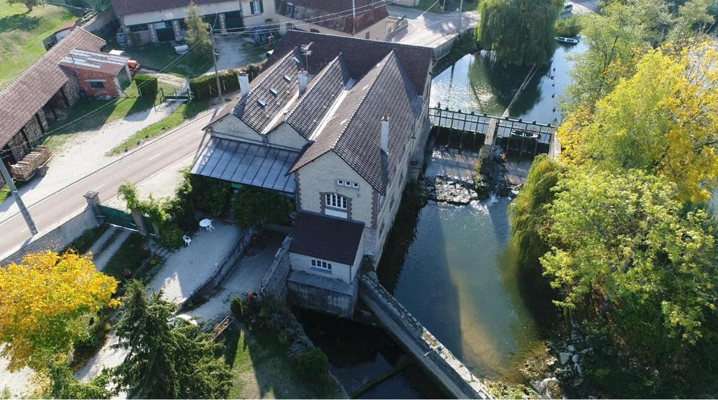 an aerial view of a house with a river at Moulin de Chappes in Chappes
