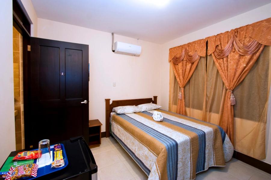 Postel nebo postele na pokoji v ubytování Hotel El Cerro