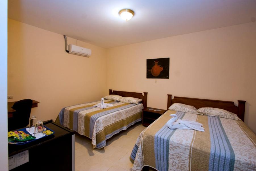 Postel nebo postele na pokoji v ubytování Hotel El Cerro