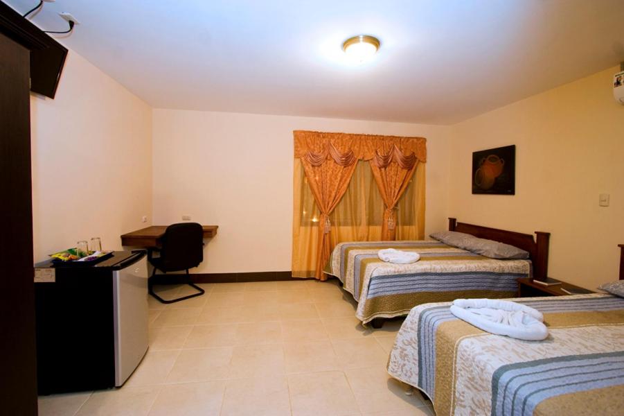 Postel nebo postele na pokoji v ubytování Hotel El Cerro