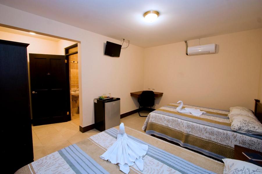 Postel nebo postele na pokoji v ubytování Hotel El Cerro