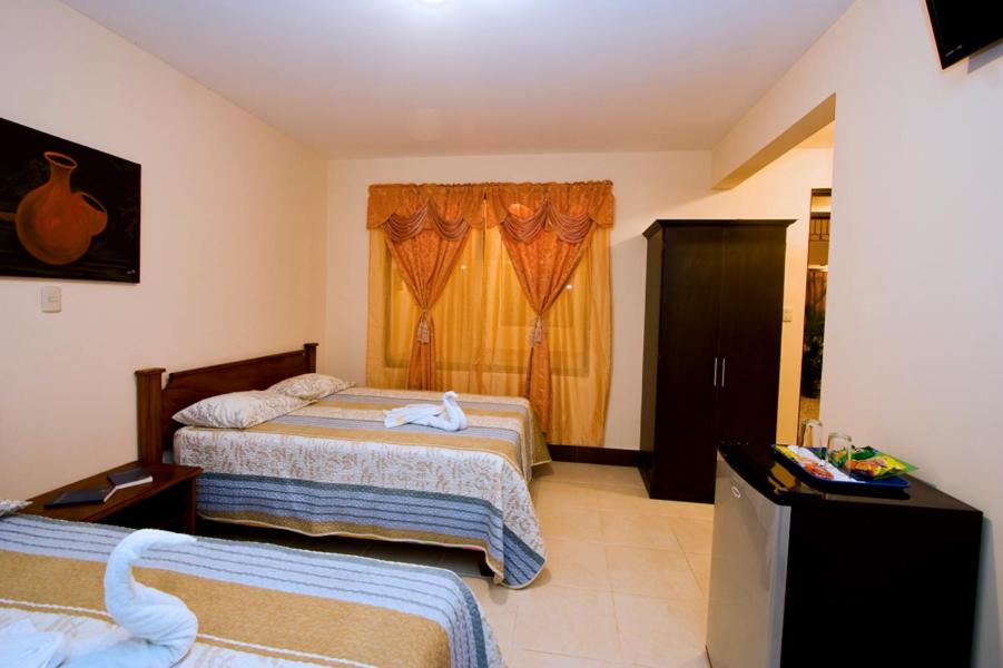 Postel nebo postele na pokoji v ubytování Hotel El Cerro