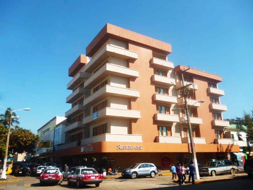 a tall building with cars parked in front of it at Hotel Valgrande in Coatzacoalcos