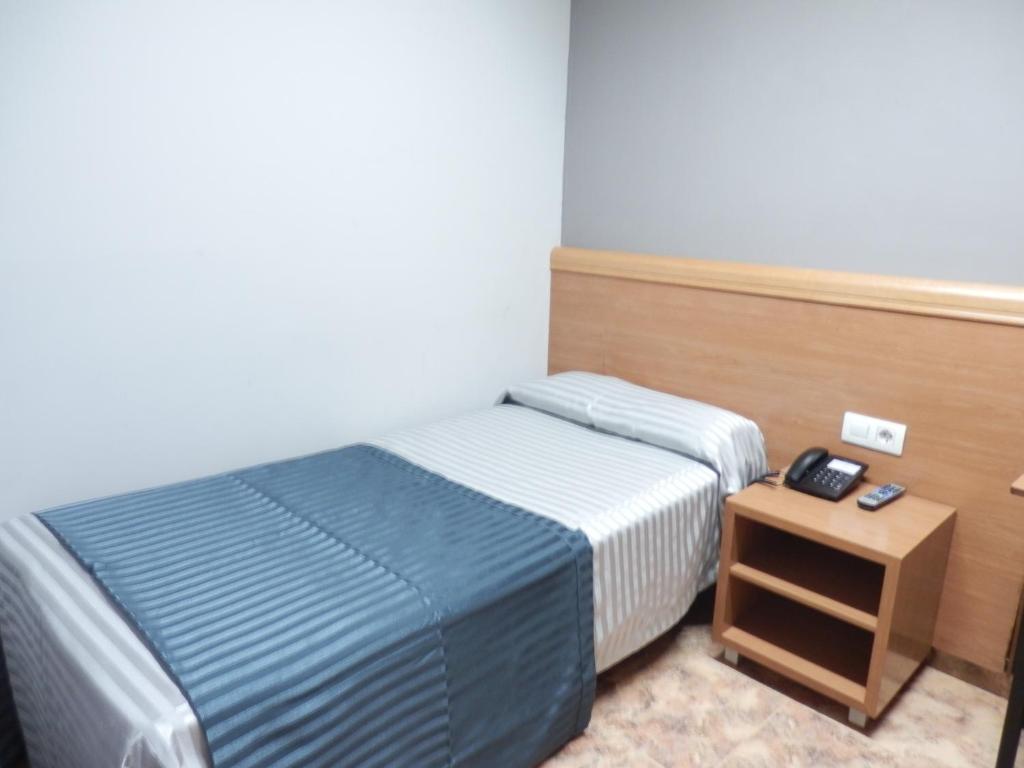Postel nebo postele na pokoji v ubytování Hotel Inglés