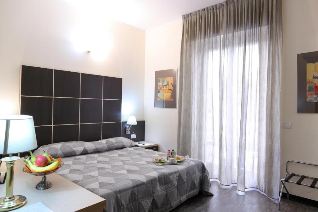 Postel nebo postele na pokoji v ubytování Hotel Ferrari