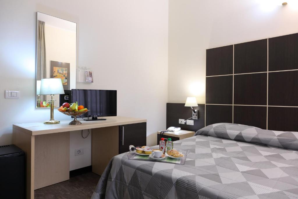 Postel nebo postele na pokoji v ubytování Hotel Ferrari