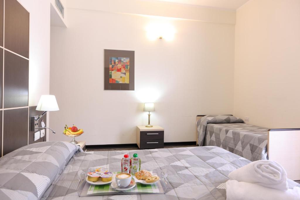 Postel nebo postele na pokoji v ubytování Hotel Ferrari
