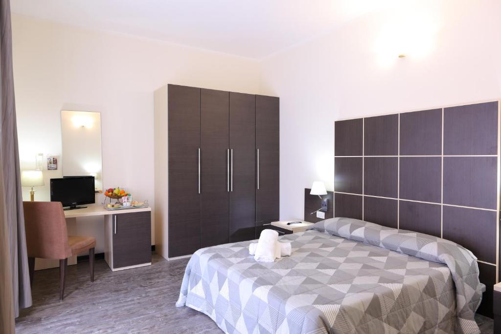 Postel nebo postele na pokoji v ubytování Hotel Ferrari