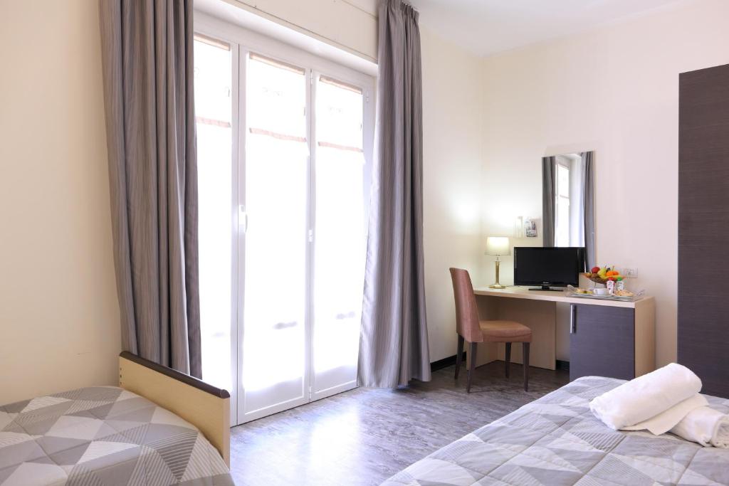 Postel nebo postele na pokoji v ubytování Hotel Ferrari