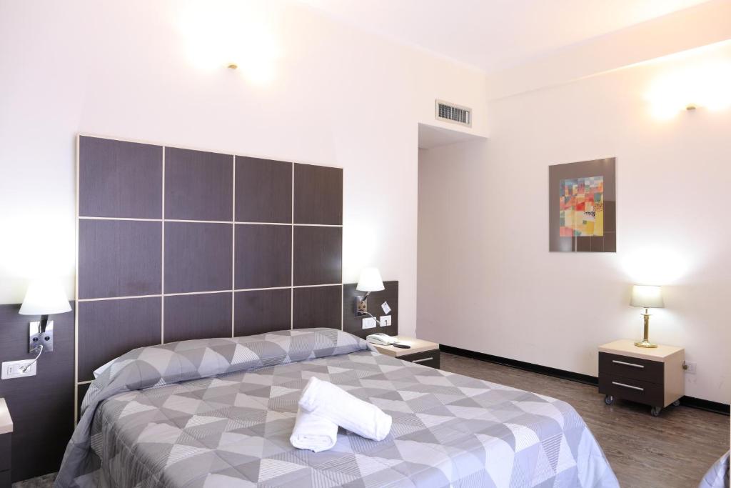 Postel nebo postele na pokoji v ubytování Hotel Ferrari
