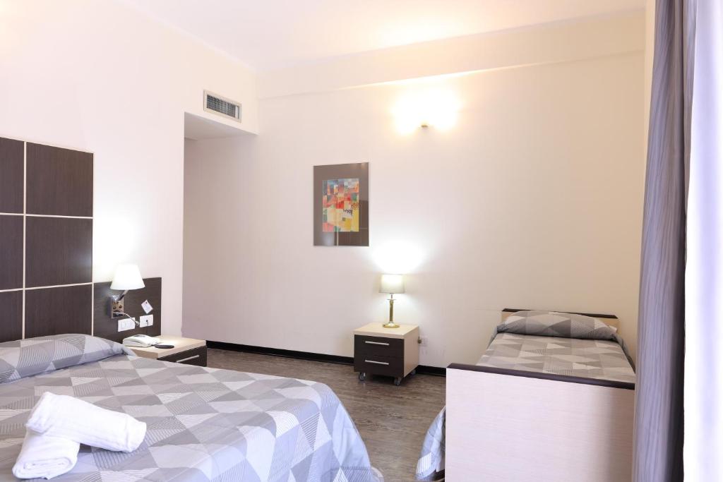 Postel nebo postele na pokoji v ubytování Hotel Ferrari
