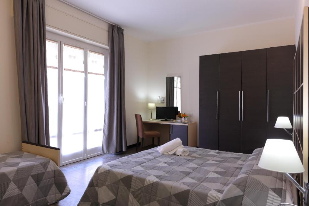 Postel nebo postele na pokoji v ubytování Hotel Ferrari